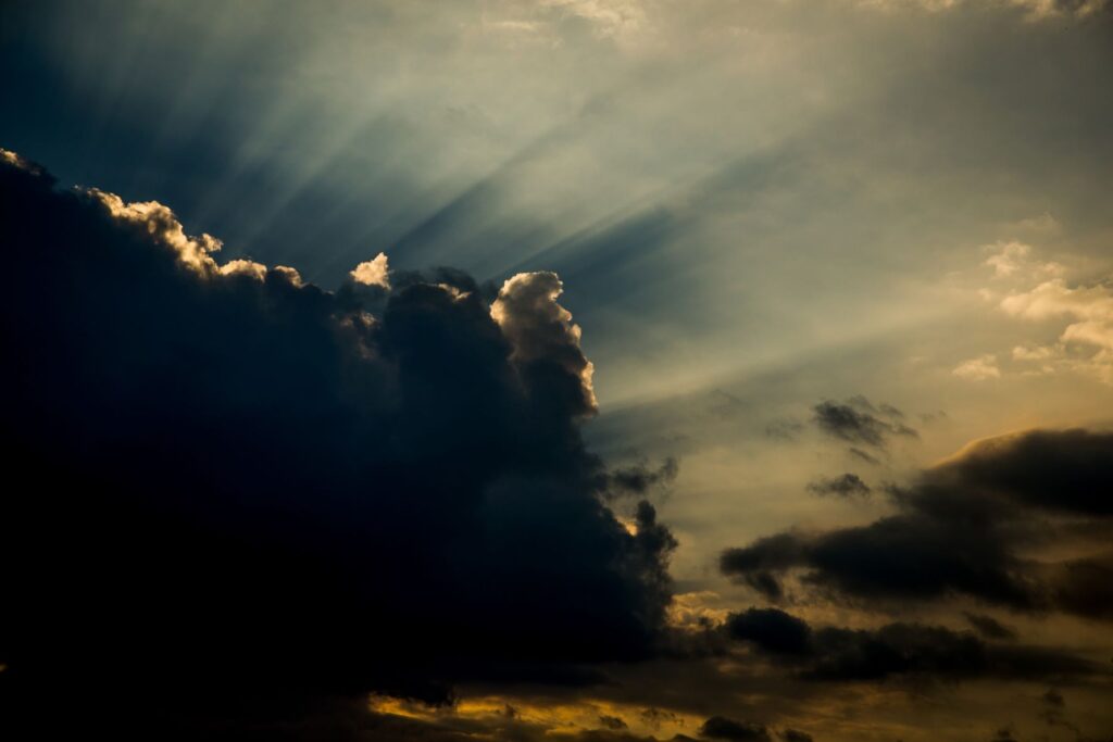 a ray of light against a dark cloud